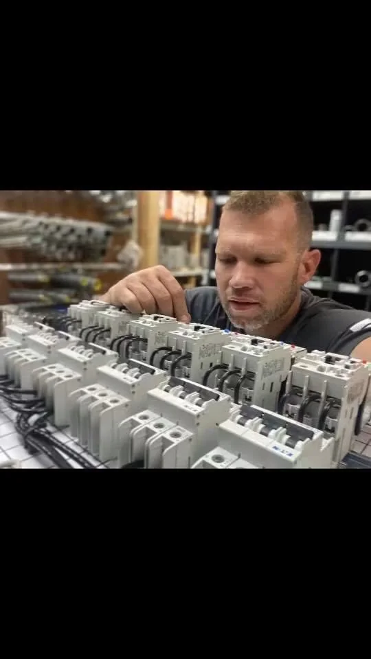 A & I team member carefully assembling electrical control equipment